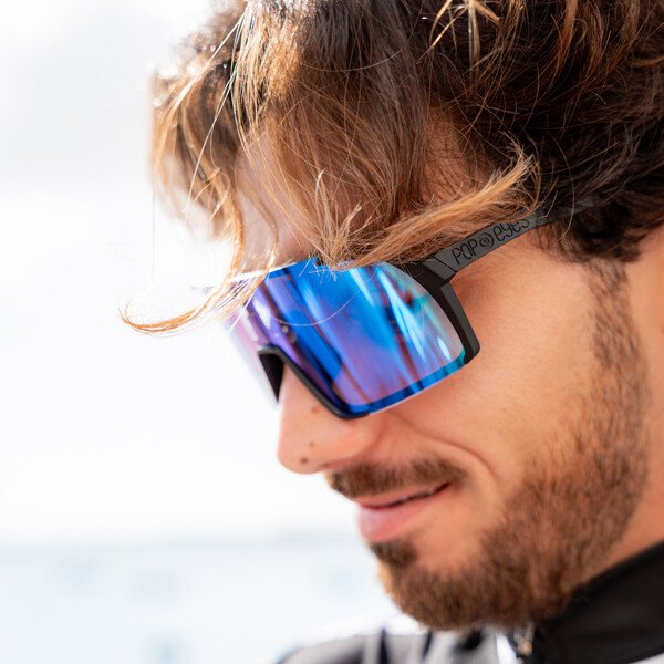 EDDY Photochromatic Black Ocean Blue – detailed sports sunglasses shot on road bike, top performance.
